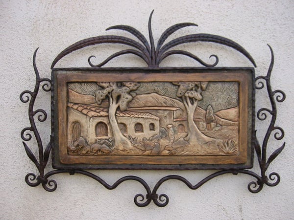 Framed relief tile, 9" X 18," by Stephenson; wrought iron frame by Bushere & Son Iron Studio in Los Angeles, California.  bird sculptures