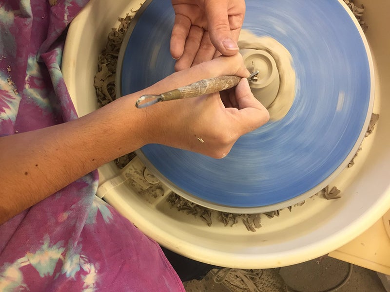 student works on ceramicware
