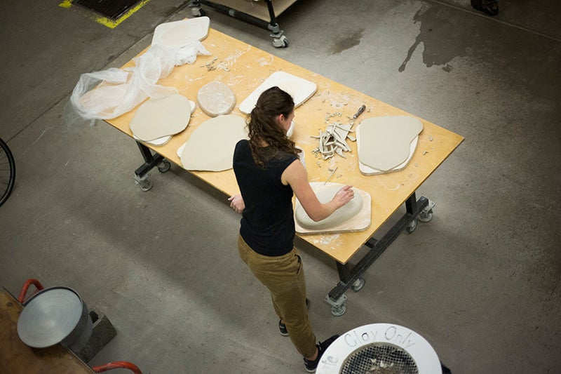 Isabel McDowall removes air bubbles from a dinner plate