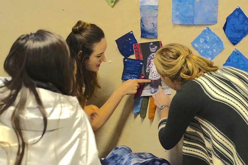 Students examine dyed textile swatches