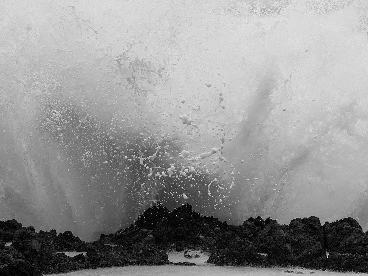 Black and white photo of a wave crashing