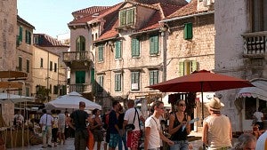 people in courtyard with stone buildings during Croatia Field School