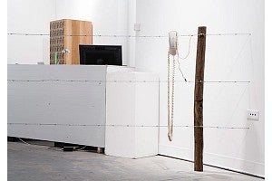 David Rueter artwork: telephones, fence posts, barbed wire, test leads, 9v battery, work gloves