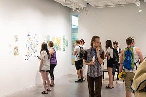 Families and friends gathere in the LaVerne Krause Gallery in Lawrence Hall to honor the work of Art + Design graduates.