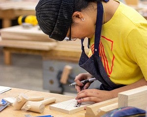 student working with wood