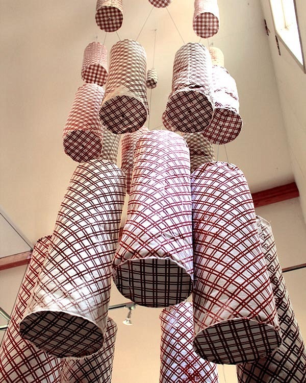fabric cylinders hang from ceiling