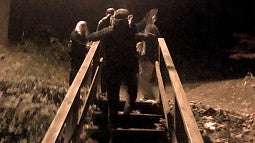 Photo of staircase with people at night