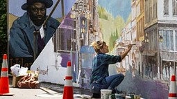 Artist working on a mural