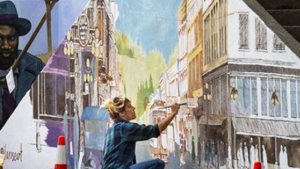 artist working on a mural