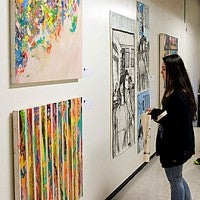 people look at artwork at the 2016 Spring Storm exhibit
