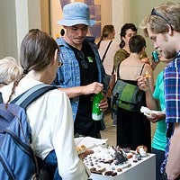 students examine artwork