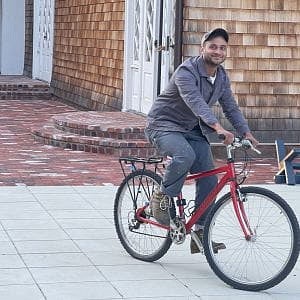 Photograph of Abhishek on a bike in the northeast from his time in the Yale Norfolk School of Art. 