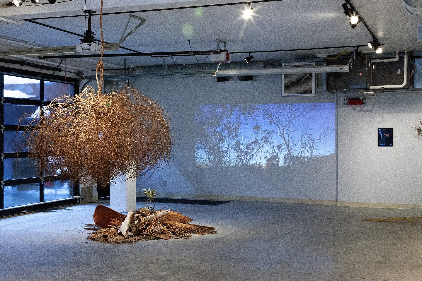 A different angle of Gabie Strong's exhibit in the Garage Door Gallery. Showcases a myriad of different artistic pieces in different art mediums, including sculpture and digital. 