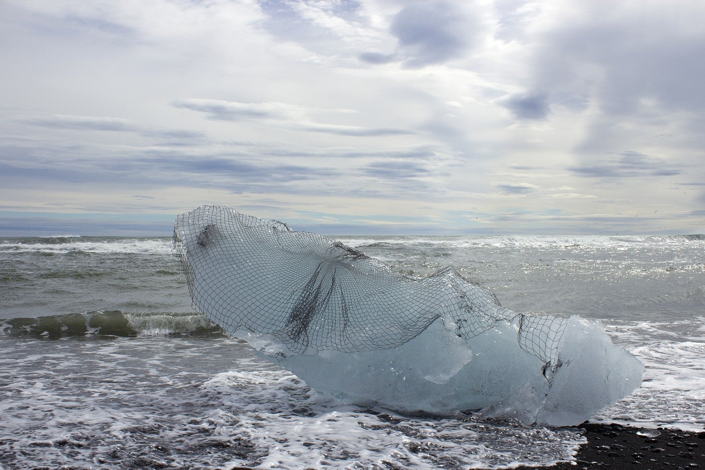 Photograph of a ice block on a beach. 