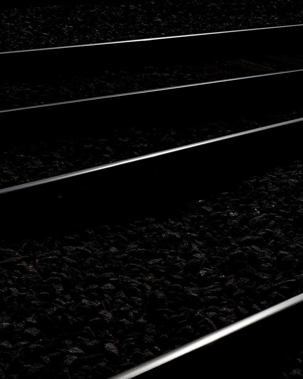 Black and white photo of train tracks to symbolize the divide between black and white communities in Tulsa. 