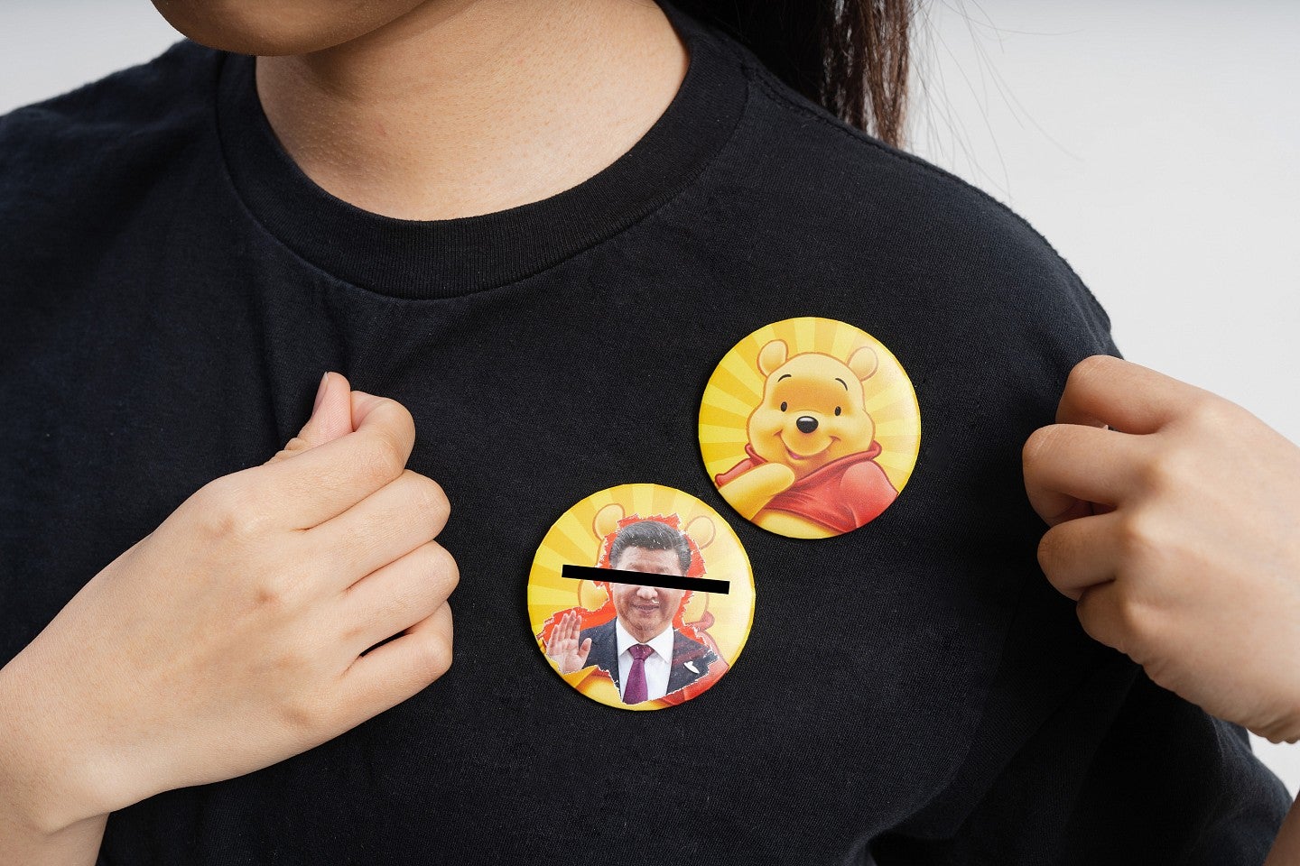 Photograph of a couple of buttons on a shirt. 