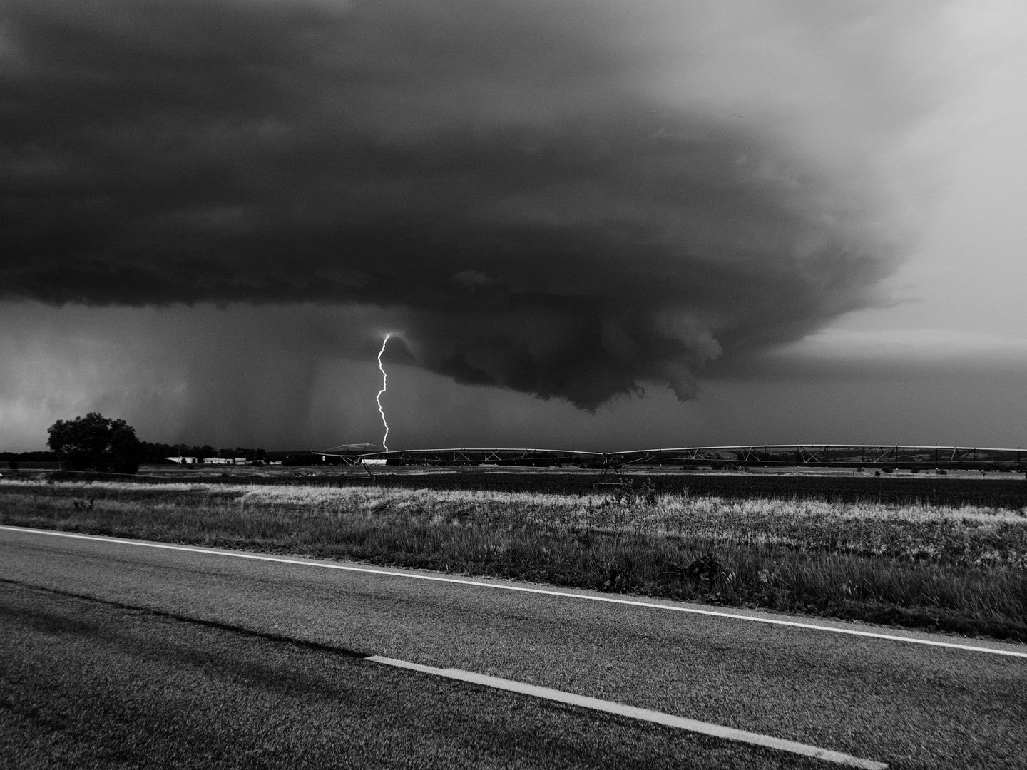 Photograph of a lightning bolt hitting the ground. 