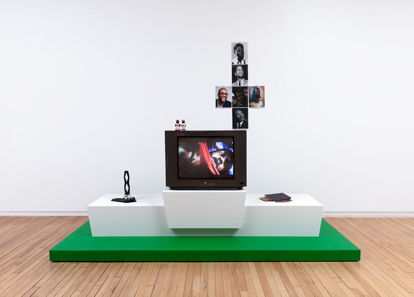 Photograph of Zora Murff's sculpture, Metaspectacle, from his Race/Hustle exhibition. Shows a collection of objects arranged in an exhibit. 