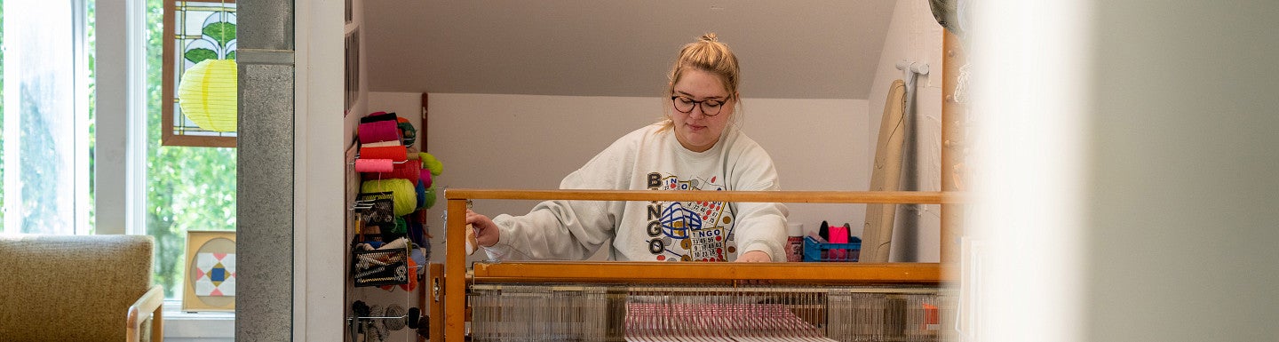 Photograph of an MFA student in their studio space. 