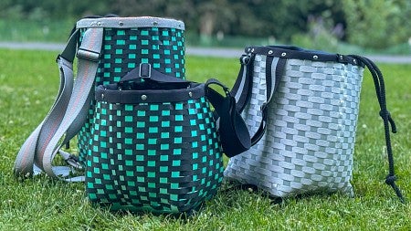 three woven baskets in the grass