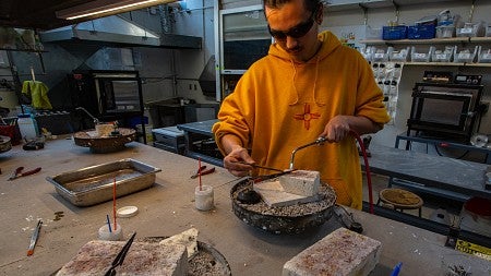 Photograph of a student using a blowtorch.
