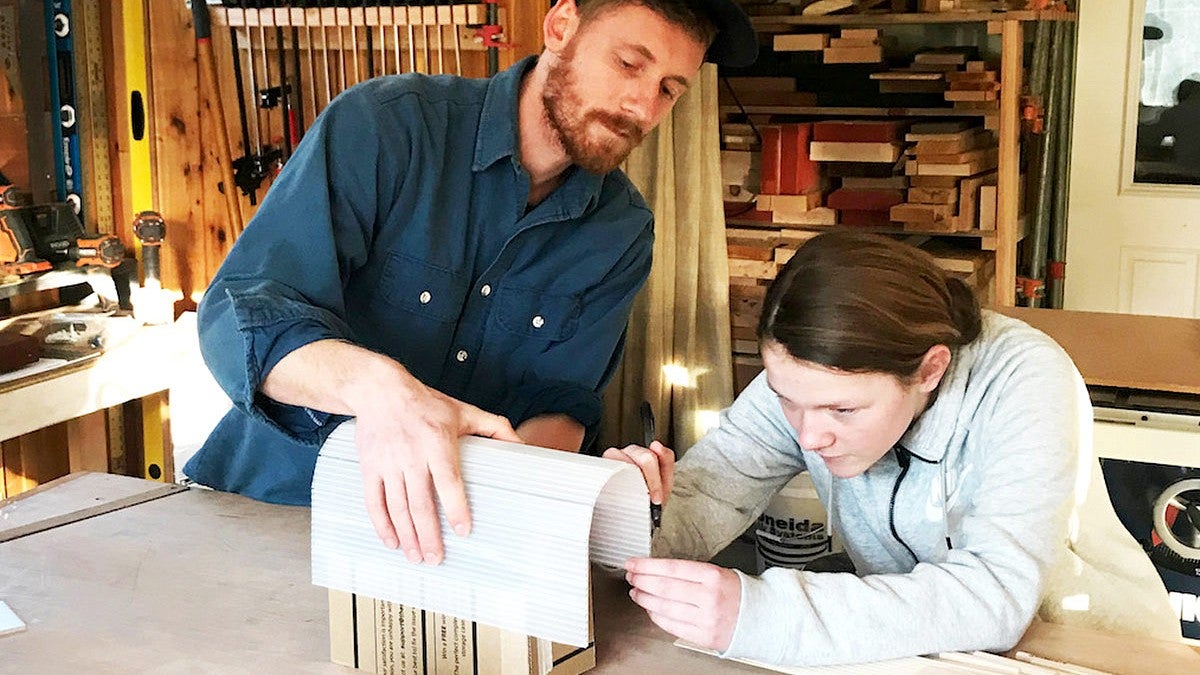 photo of a mentor and student working at a draft table