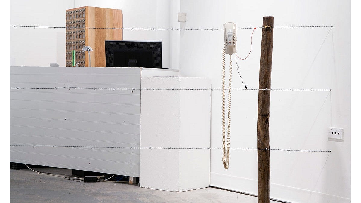 David Rueter artwork: telephones, fence posts, barbed wire, test leads, 9v battery, work gloves