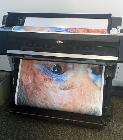 large format printer with close up photo of a face 