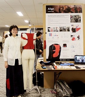 Photograph of Audrey Saing in front of her Align prototype. 