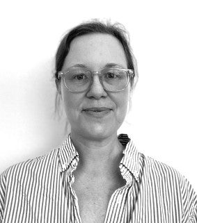Headshot of the artist, Dawn Cerny. Woman looks into the camera with glasses and hair pulled back. Photo is in black and white. 