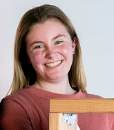 Photograph of a femme presenting student looking into the camera. 