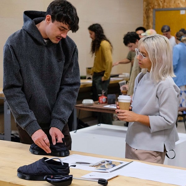 two people looking at a shoe design