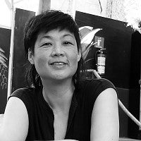 Photograph of Patty Chang in front of their works. 