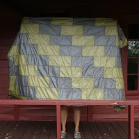 a yellow and grey patterned quilt